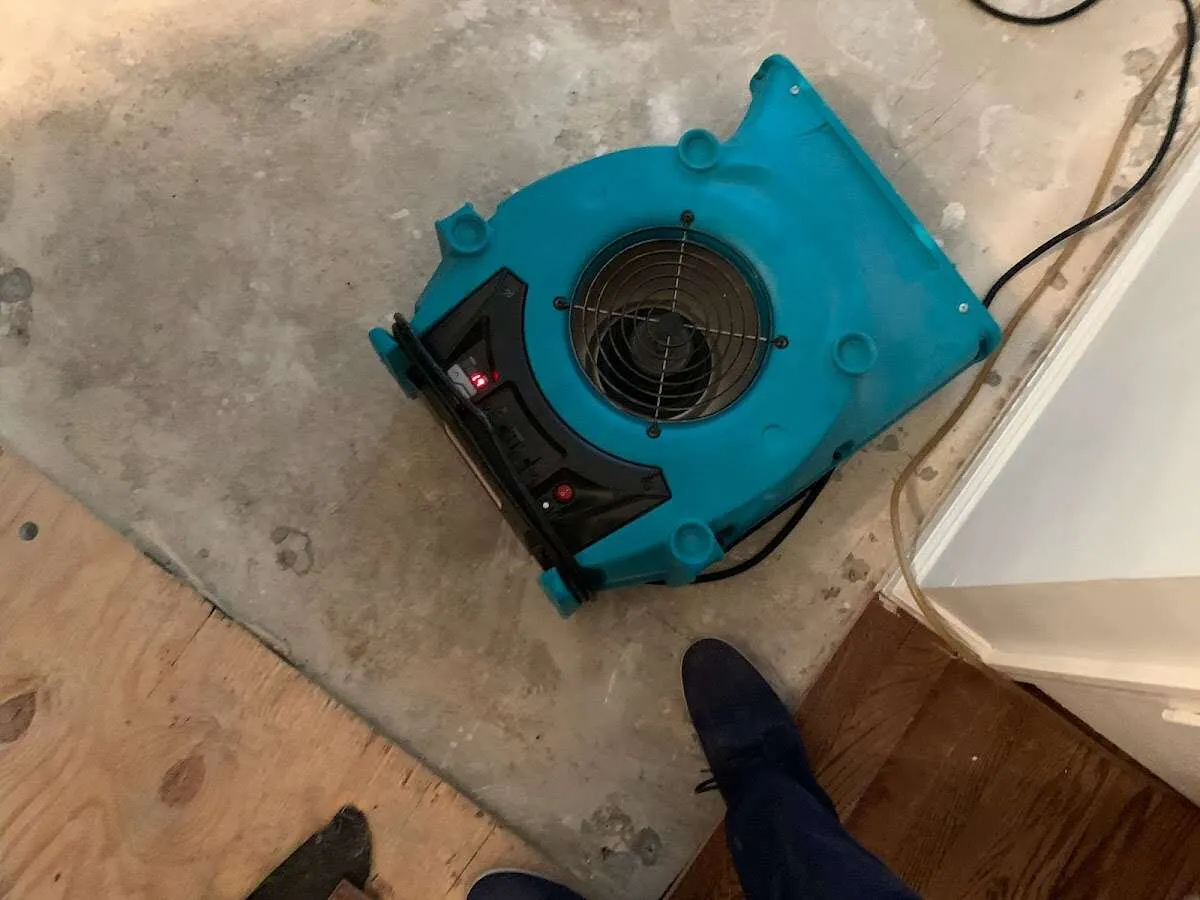 Air mover drying subfloor during Commercial Water Damage Restoration in Carmel